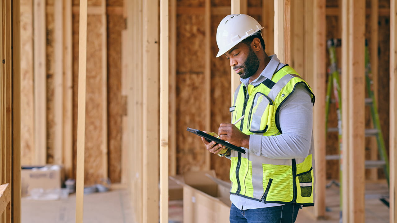 man with tablet in construction
