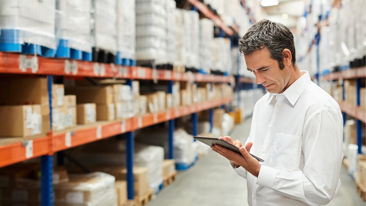 man with tablet in warehouse