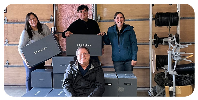Andrea Gusty and other teammates from The Kuskokwim Corporation deliver internet receivers to residents.