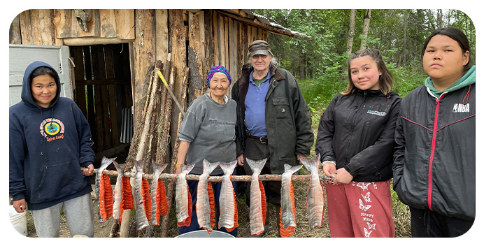 Shareholders of The Kuskokwim Corporation prepare salmon to smoke and preserve in the Kuskokwim River region. They will subsist on the dried salmon throughout the winter.