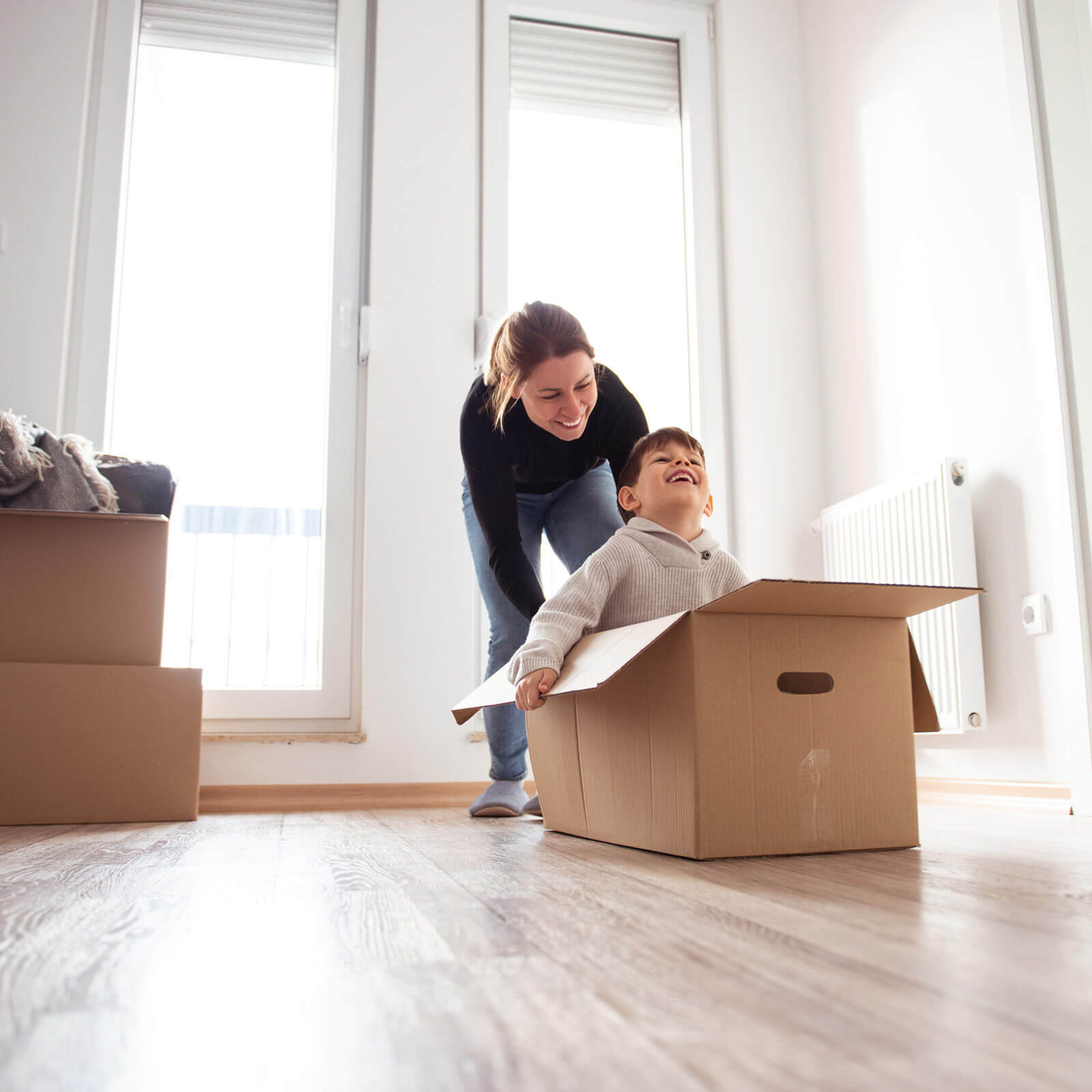 mother and son playing in packing box